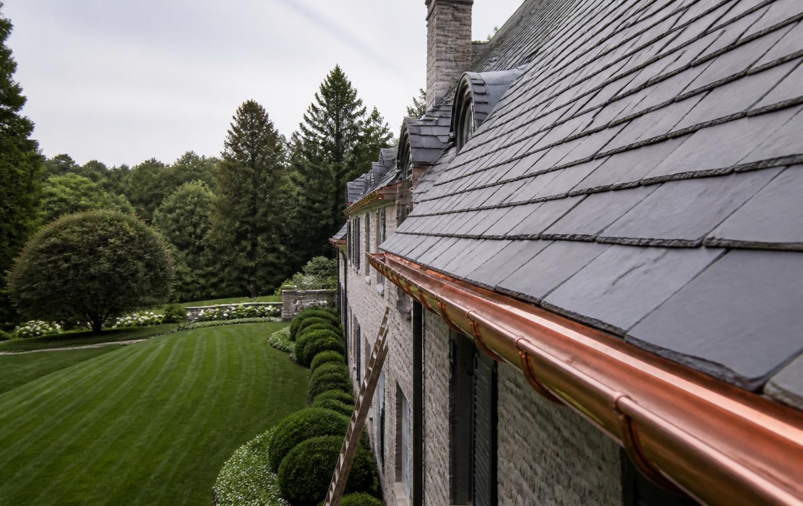 Slate roof and copper gutters on a Charlotte estate overlooking manicured gardens