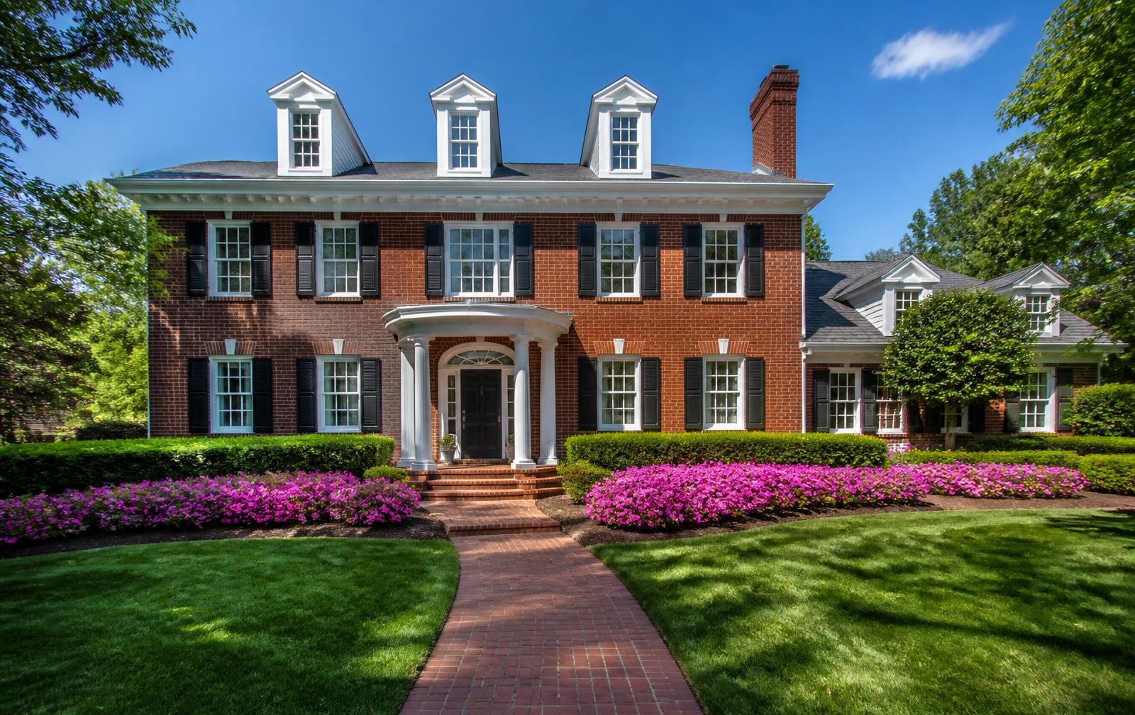 Brick Colonial home with blooming azaleas in Foxcroft, Charlotte NC